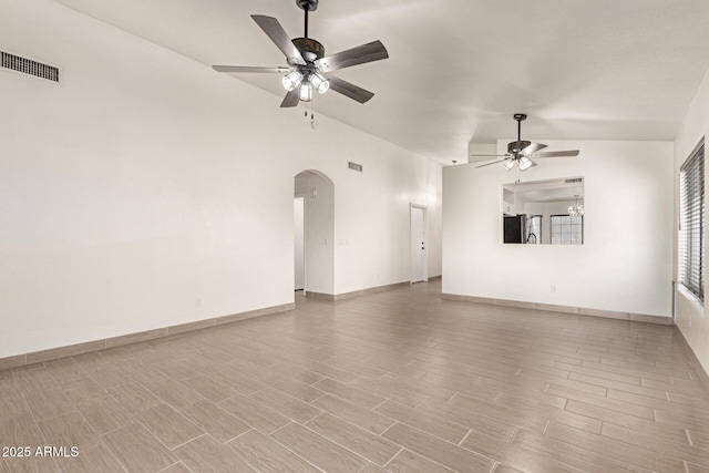 unfurnished living room with ceiling fan and lofted ceiling