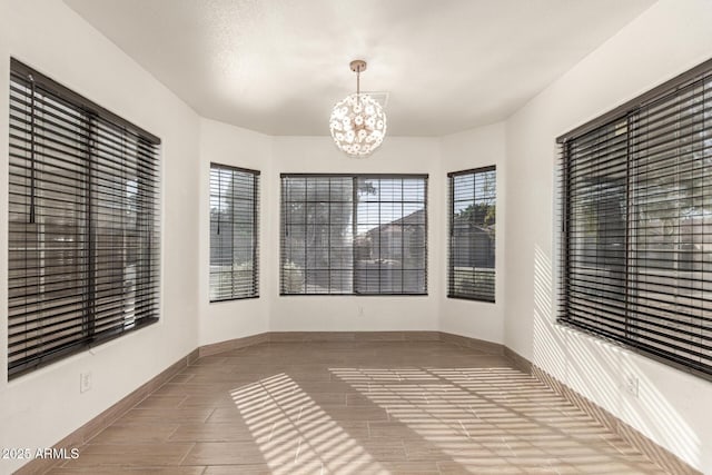 unfurnished sunroom featuring a notable chandelier