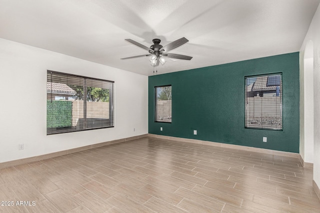 spare room with ceiling fan and light hardwood / wood-style floors