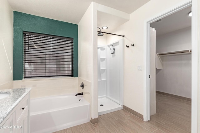 bathroom with vanity and independent shower and bath