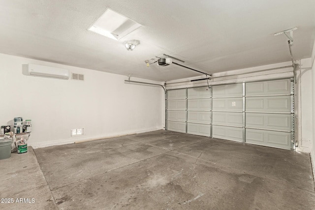 garage featuring a wall mounted AC and a garage door opener