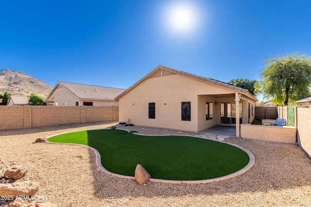 rear view of house featuring a patio area and a mountain view