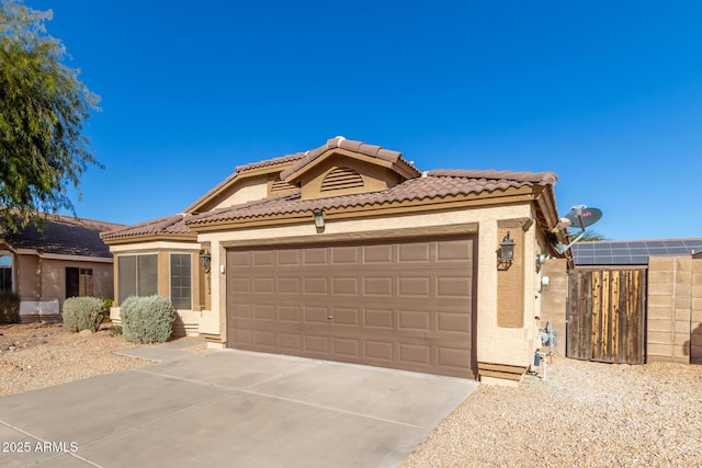 view of front of home with a garage and solar panels