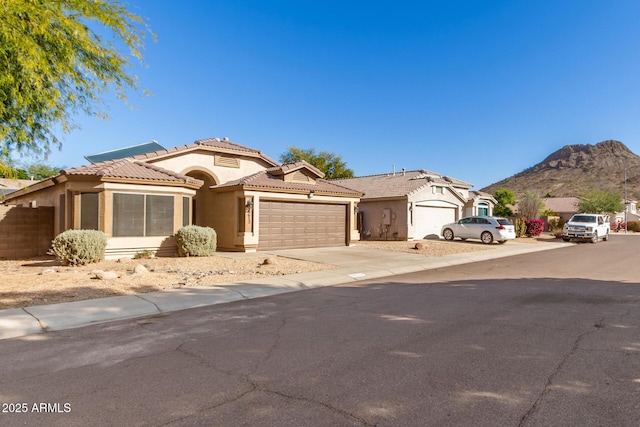 view of front of home featuring a garage and a mountain view