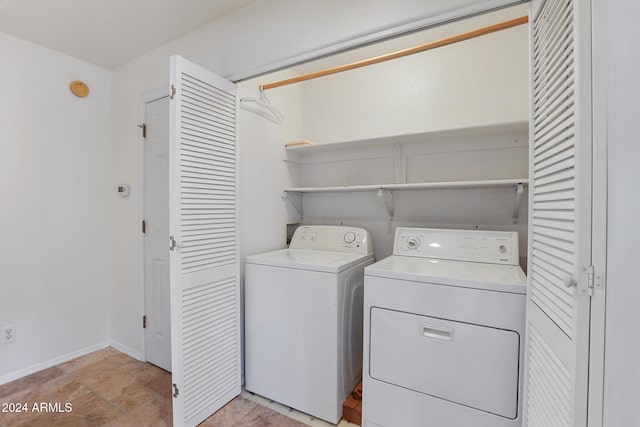 clothes washing area featuring washer and dryer