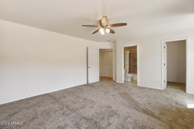 unfurnished bedroom featuring carpet floors, ensuite bath, and ceiling fan