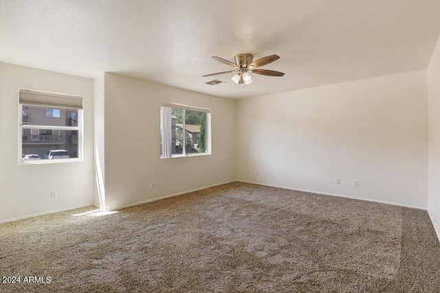 unfurnished room featuring ceiling fan and carpet floors