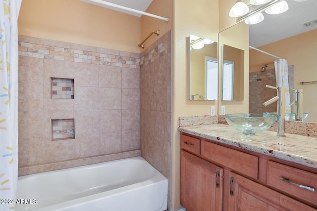 bathroom featuring vanity and shower / bath combination with curtain