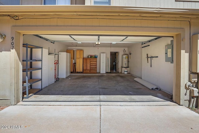 garage featuring secured water heater, a garage door opener, and electric panel