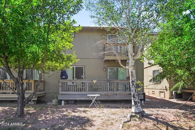 rear view of house with a wooden deck