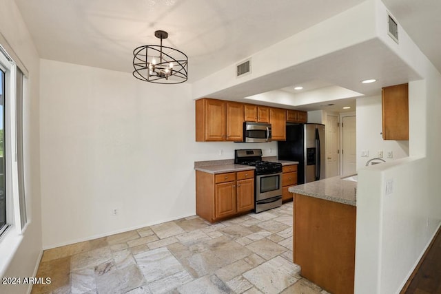 kitchen featuring sink, stainless steel appliances, light stone counters, a chandelier, and decorative light fixtures