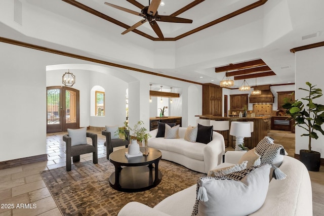 14760 E Paradise Dr, Fountain Hills, AZ 85268 - living area featuring arched walkways, ceiling fan, ornamental molding, a tray ceiling, and a high ceiling