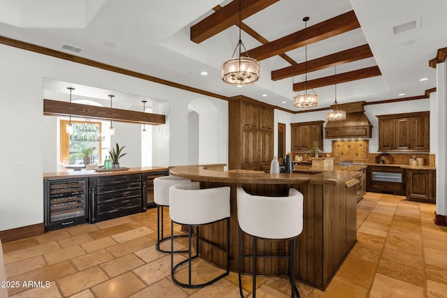 14760 E Paradise Dr, Fountain Hills, AZ 85268 - kitchen with beverage cooler, custom range hood, a raised ceiling, arched walkways, and dark countertops