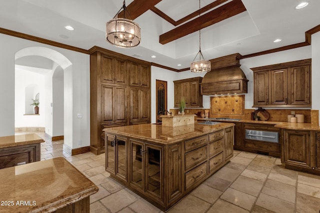 14760 E Paradise Dr, Fountain Hills, AZ 85268 - kitchen featuring custom exhaust hood, a warming drawer, arched walkways, stone tile flooring, and recessed lighting