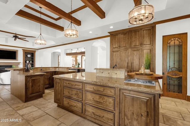 14760 E Paradise Dr, Fountain Hills, AZ 85268 - kitchen featuring arched walkways, a center island, stone tile floors, a chandelier, and a towering ceiling