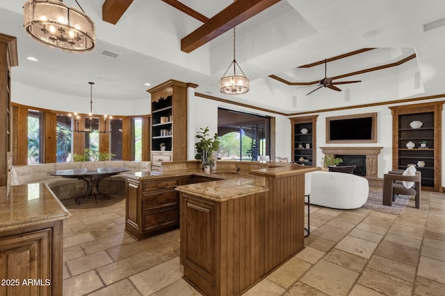 14760 E Paradise Dr, Fountain Hills, AZ 85268 - kitchen with stone tile flooring, a fireplace, a chandelier, a towering ceiling, and a breakfast bar