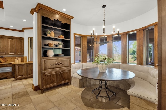 14760 E Paradise Dr, Fountain Hills, AZ 85268 - dining area with stone tile floors, a chandelier, recessed lighting, ornamental molding, and built in features