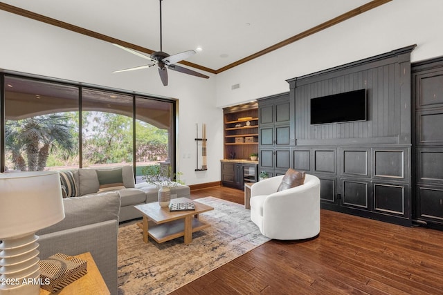 14760 E Paradise Dr, Fountain Hills, AZ 85268 - living area featuring ornamental molding, dark wood-style flooring, a ceiling fan, baseboards, and a high ceiling