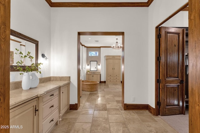 14760 E Paradise Dr, Fountain Hills, AZ 85268 - bathroom with baseboards, crown molding, vanity, stone tile floors, and a chandelier
