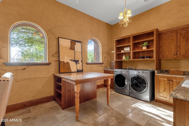 14760 E Paradise Dr, Fountain Hills, AZ 85268 - laundry area with washing machine and dryer, cabinet space, a chandelier, and stone tile floors