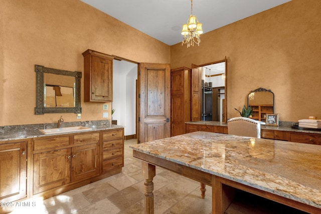 14760 E Paradise Dr, Fountain Hills, AZ 85268 - kitchen with a sink, brown cabinetry, a chandelier, decorative light fixtures, and light stone counters