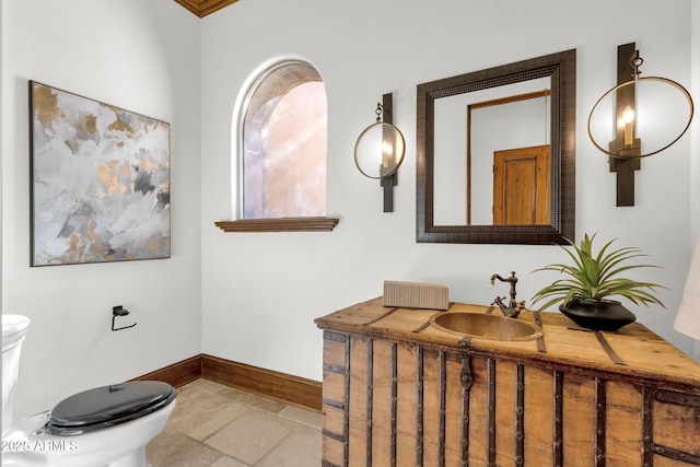 14760 E Paradise Dr, Fountain Hills, AZ 85268 - bathroom featuring toilet, baseboards, vanity, and stone tile floors