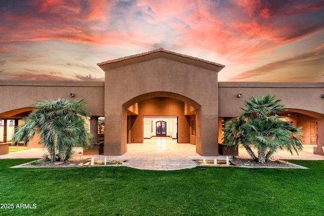 14760 E Paradise Dr, Fountain Hills, AZ 85268 - view of exterior entry featuring a yard and stucco siding