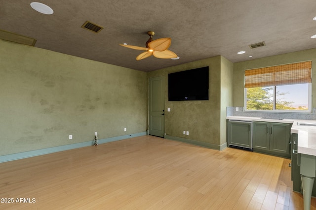 14760 E Paradise Dr, Fountain Hills, AZ 85268 - unfurnished living room featuring light wood-style floors, ceiling fan, recessed lighting, baseboards, and a sink