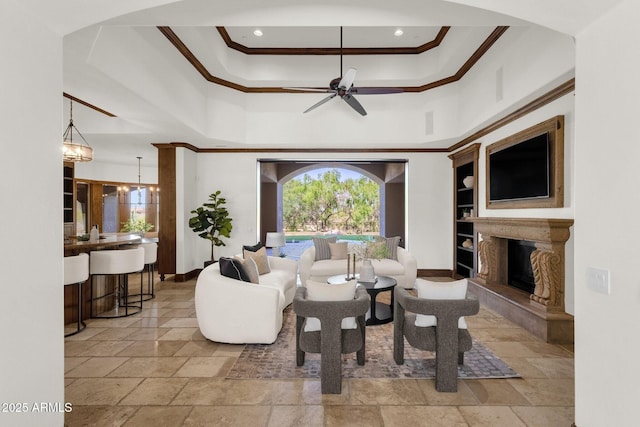 14760 E Paradise Dr, Fountain Hills, AZ 85268 - living area with a premium fireplace, a ceiling fan, a towering ceiling, ornamental molding, and stone tile floors