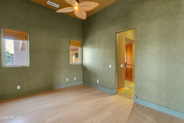 14760 E Paradise Dr, Fountain Hills, AZ 85268 - spare room with wood finished floors, a ceiling fan, plenty of natural light, a high ceiling, and baseboards