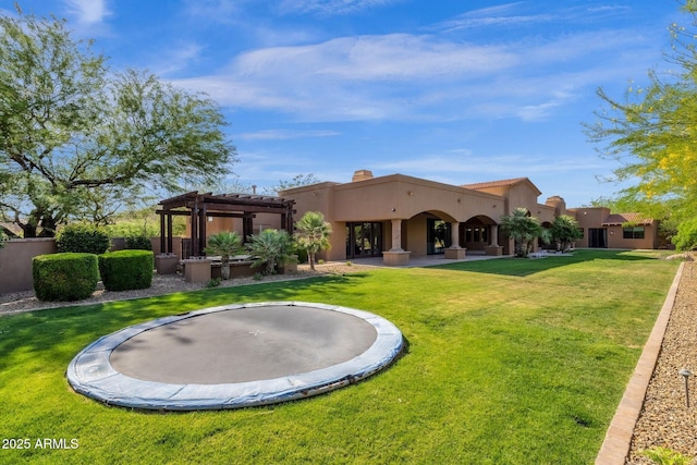 14760 E Paradise Dr, Fountain Hills, AZ 85268 - back of property with a trampoline, a pergola, stucco siding, and a lawn