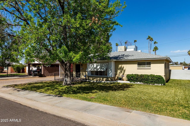 view of front of house with an attached carport, brick siding, fence, concrete driveway, and a front yard