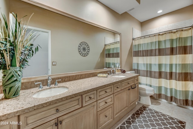 bathroom featuring vanity, tile patterned floors, and toilet