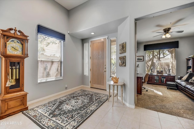 foyer entrance featuring ceiling fan and light tile patterned flooring