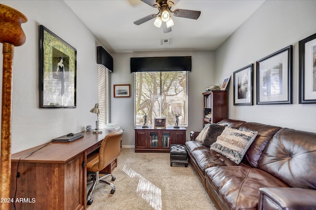 carpeted office featuring ceiling fan