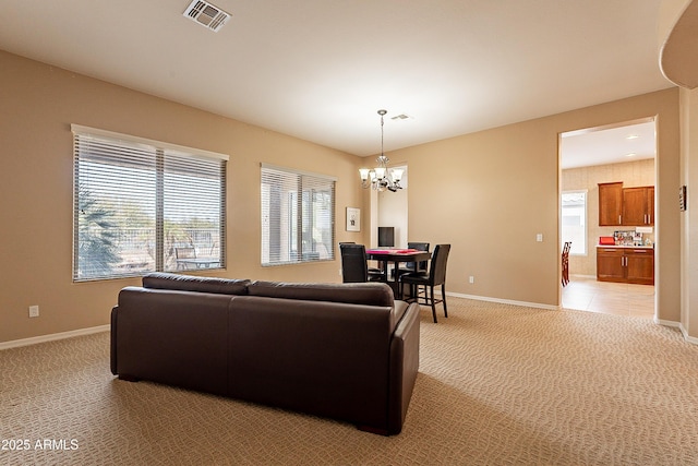 living area with light carpet, baseboards, and visible vents