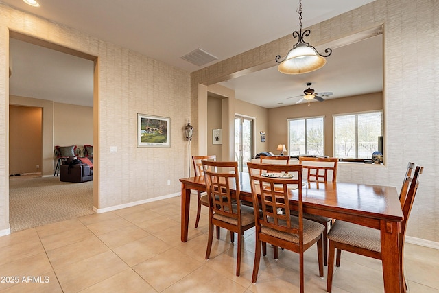 dining room with wallpapered walls, baseboards, and visible vents