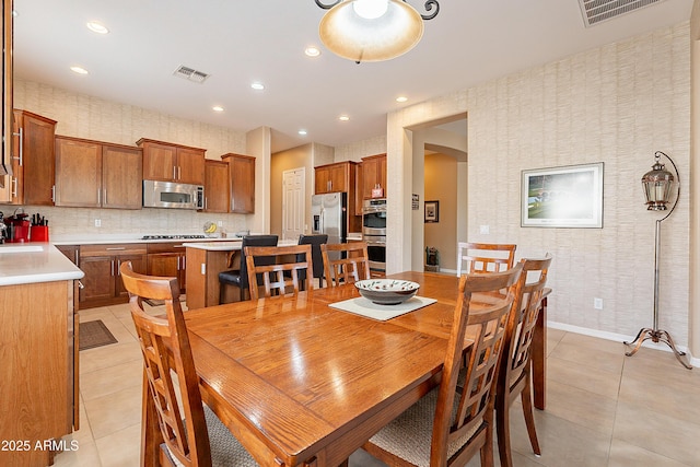 dining area featuring light tile patterned floors, recessed lighting, visible vents, and wallpapered walls