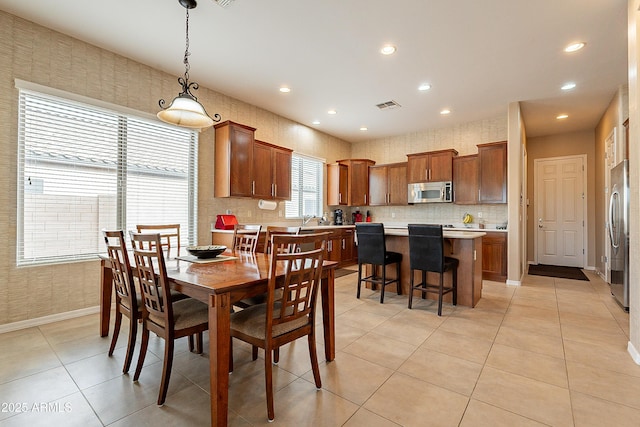 dining area with light tile patterned floors, visible vents, baseboards, and recessed lighting