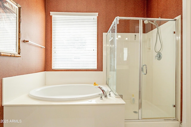 bathroom with a garden tub and a shower stall