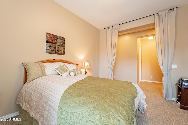 carpeted bedroom featuring baseboards