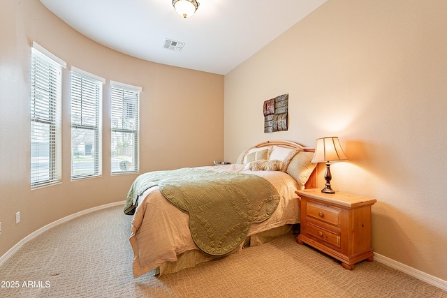 bedroom with lofted ceiling, visible vents, light carpet, and baseboards