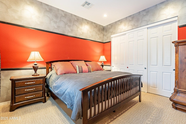 bedroom with a closet, carpet, and visible vents