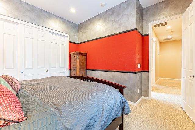 bedroom featuring a closet, carpet, visible vents, and baseboards