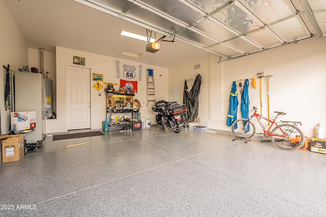 garage featuring water heater and a garage door opener