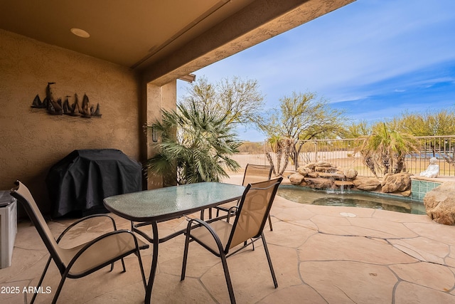 view of patio featuring a fenced backyard, a fenced in pool, and outdoor dining space