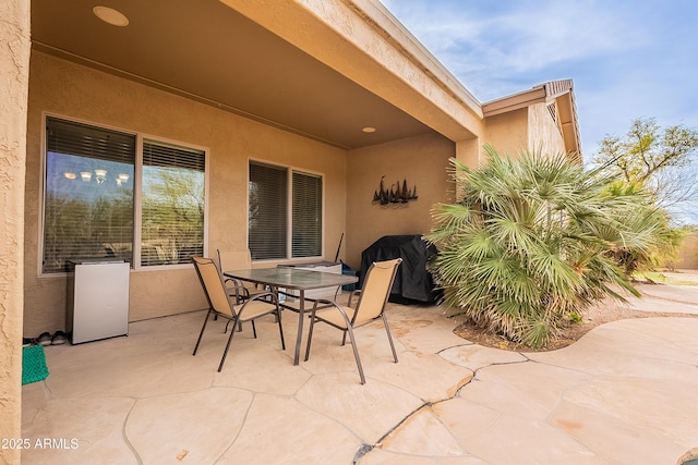 view of patio featuring area for grilling and outdoor dining space