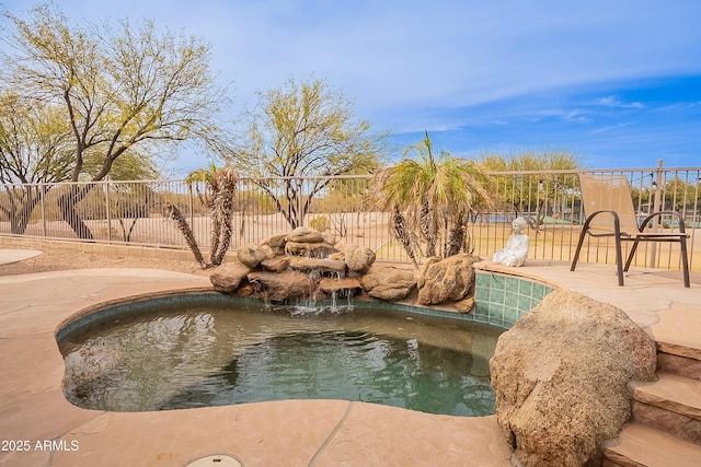 view of swimming pool featuring fence