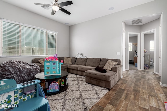 living room featuring ceiling fan, hardwood / wood-style floors, and a healthy amount of sunlight