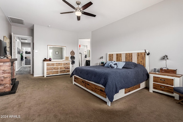 carpeted bedroom with ceiling fan and ensuite bath